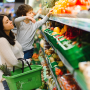Woman grocery shopping with a child