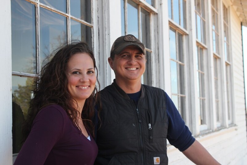 Flanked by the 1928 schoolhouse, Aaron is the face of Base Vines & Cattle side-stream ventures and Jennifer is the logistical captain.