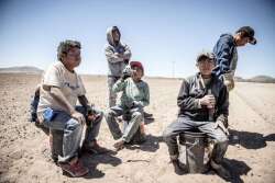 This June 13, 2017, photo shows workers from Guerrero state in Mexico taking a break after clearing rocks from Mexican farmer Pedro Suderman's fields just south of the U.S.-Mexico border.