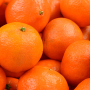 A close-up photo of a pile of mandarin oranges.