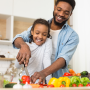 Dad and daughter working in kitchen