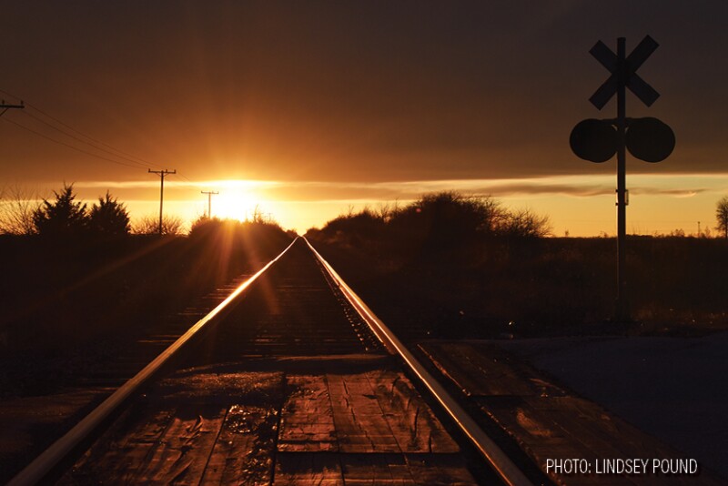 railroad train tracks sunset by Lindsey Pound