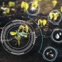 Photo of young plants in field with technology symbols overlayed