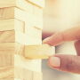 Man pulling block out of Jenga game