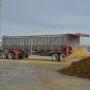 A semi dumping wet distillers grain at a feedlot.