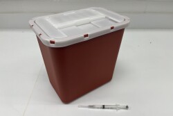 A sharps container safely stores medical waster.