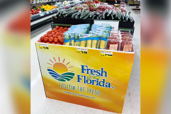 An orange and yellow display bin with the Fresh From Florida logo, containing various type of produce