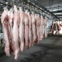 FILE PHOTO: Employees work at a pig slaughtering and pork processing plant in Huaian, Jiangsu province, China April 9, 2020. China Daily via REUTERS/File Photo