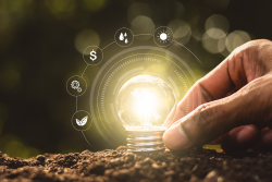 agtech photo illustration of hand placing light bulb in soil