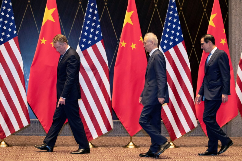 FILE PHOTO: U.S. Trade Representative Robert Lighthizer points at markers on the floor as he leads Chinese Vice Premier Liu He and Treasury Secretary Steven Mnuchin to their position for a family photo at the Xijiao Conference Center in Shanghai, China, July 31, 2019. Ng Han Guan/Pool via REUTERS/File Photo