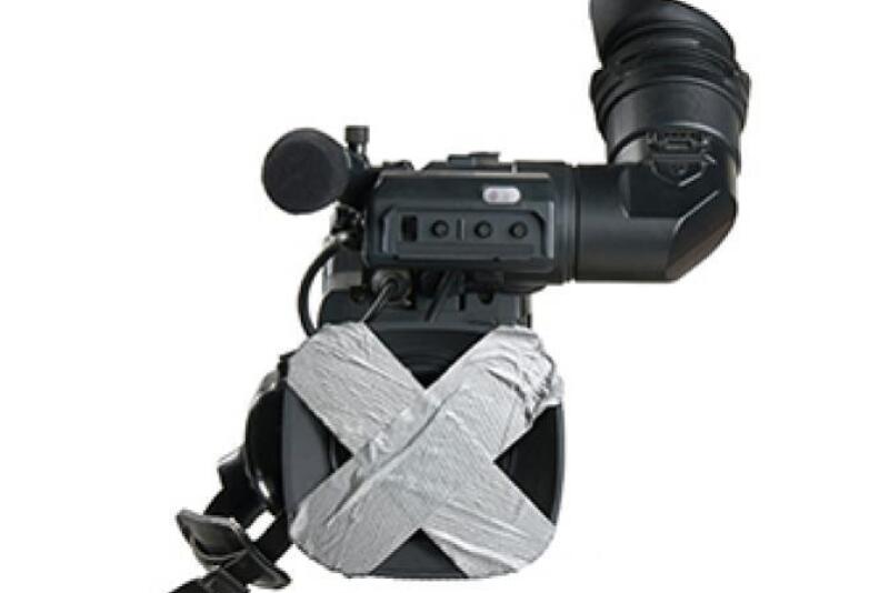 Stock photo of a camera being covered up. 
