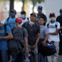 Migrants seeking a U.S. work visa are pictured as they waiting to take a bus that will take to their hotel in Monterrey, Mexico March 24, 2020.  REUTERS/Daniel Becerril