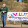 A man speaks with a festival banner in the background. Photo: Courtesy Wholesum