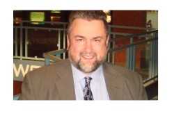 Headshot of man in suit and tie. Photo courtesy of Produce Business