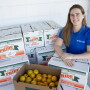  Christa Court, an economist with the University of Florida Institute of Food and Agricultural Sciences, poses with freshly harvested oranges at a student citrus sale event on the UF main campus in Gainesville -- Friday, Dec. 7, 2018. Court is part of a team that produced a new report on the economic contributions of Florida's citrus industry in the 2016-17 growing season. Total economic contributions, including multiplier effects, include $7.241 billion in industry output (sales revenue) and more than 50,000 jobs