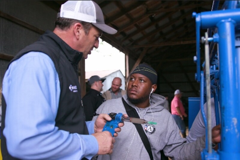 Tim Parks, D.V.M., Merck Animal Health, instructs a service member in proper vaccination techniques.
