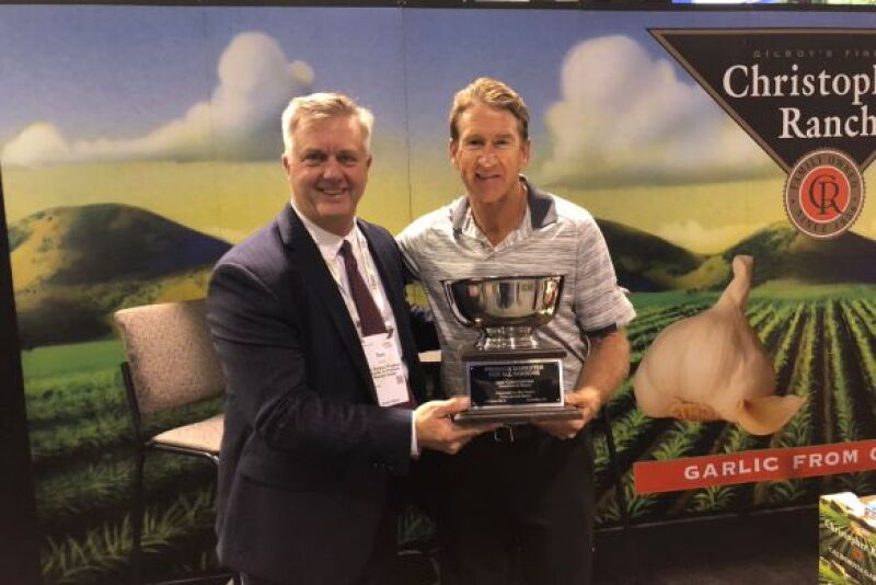 The Packer's Tom Karst (left) presents the 2019 Produce Marketer for All Seasons award to Bill Christopher of Christopher Ranch on Oct. 18, who accepted the award on behalf of his father Don Christopher.
