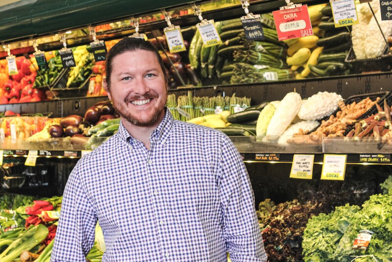 white guy with beard in front of vegetables