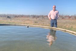 Terry Stands Next to Water Trough