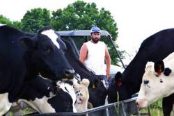 In this photo taken May 17, 2017, Ben Seaton, 21, stands on his family's dairy farm in Debusk, Tenn. Seaton takes pride in the cows he has bred and now milks each day on the farm.