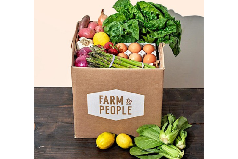 cardboard box with vegetables and eggs