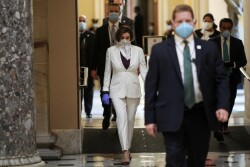 U.S. Speaker of the House Nancy Pelosi (D-CA) wears a face mask as she walks to the House Chamber ahead of a vote on an additional economic stimulus package passed earlier in the week by the U.S. Senate, on Capitol Hill in Washington, U.S., April 23, 2020. REUTERS/Tom Brenner