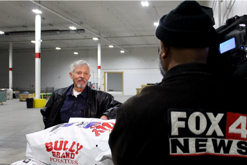 A Kansas City television station interviews Haun Potato Co. owner Dave Haun Dec. 12, at the annual potato donation he spearheads.
