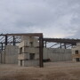 A barn being built on a farm. 