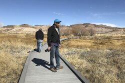 Len Warren, right, and John Zablocki from the The Nature Conservancy stand on the boardwalk at the Torrance Ranch Preserve north of Beatty, Nevada on Feb. 8, 2019. 
