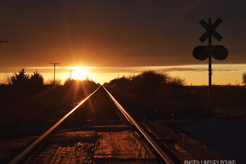 railroad train tracks sunset by Lindsey Pound