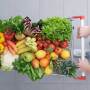 Overhead view of a shopper pushing cart full of fruits and vegetables