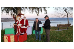 Mike Mauk, president of the Brewster, Wash., Chamber of Commerce, gives Steve Stewart (far right), assistant general manager of Honeybear Growers, a certificate in recognition of the company's contributions to the community.
