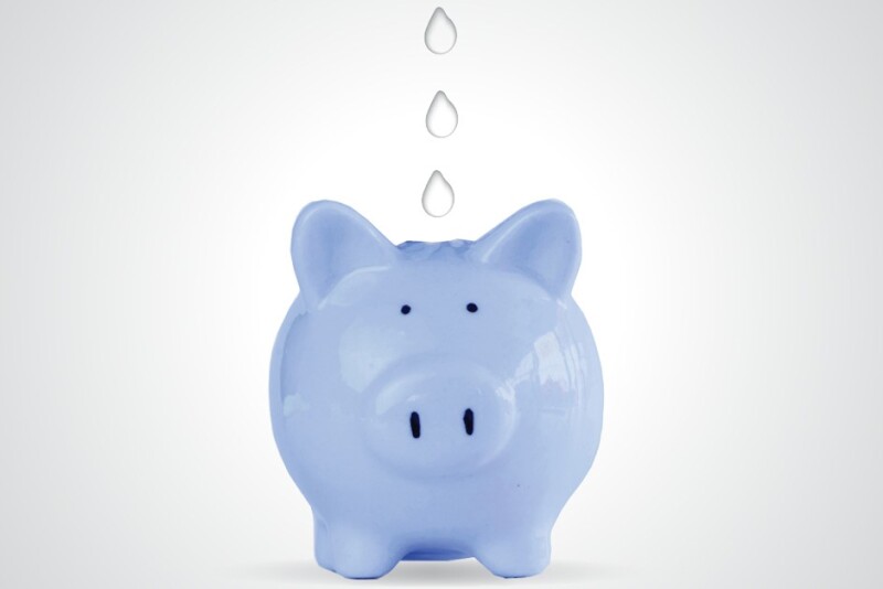 A blue piggy bank with water droplets