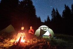 Two people at a campfire