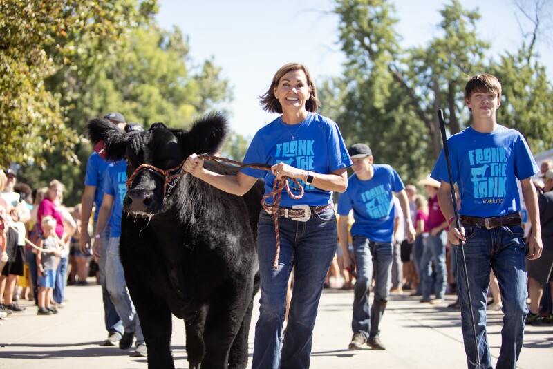 Iowa Governor Kim Reynolds, youth exhibitor Marcus Gaul and steer Frank the Tank.