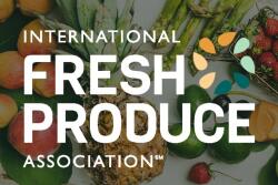 A collection of whole fresh fruit on a wooden table as seen from above with the text "International Fresh Produce Association" superimposed over the image.