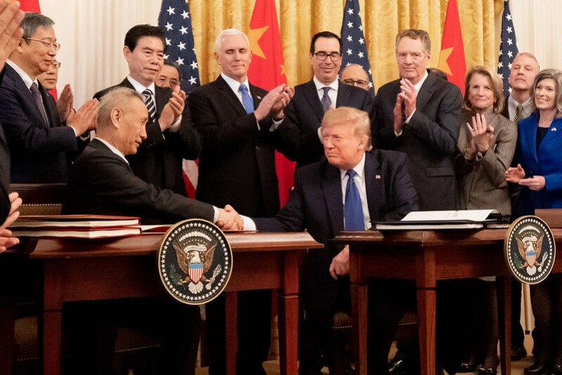 Chinese Vice Premier Liu He and President Donald Trump shake hands after signing phase one of a trade agreement.