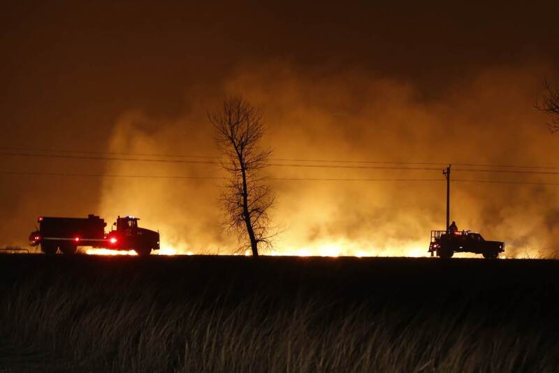 Firefighters from across Kansas and Oklahoma battle a wildfire near Protection, Kan., Monday, March 6, 2017.