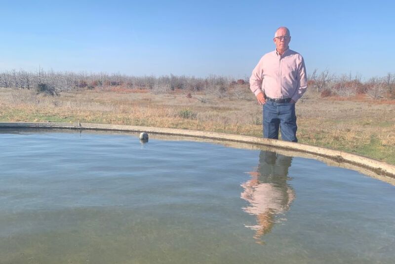 Terry Stands Next to Water Trough