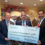 Walt Dasher, center, presents a check to the Future Farmers of American organization.