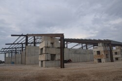 A barn being built on a farm. 