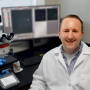 Assistant Professor Karl Kerns with THUNDER epifluorescent microscope in his lab