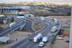 Trucks approach U.S. border from Mexico.