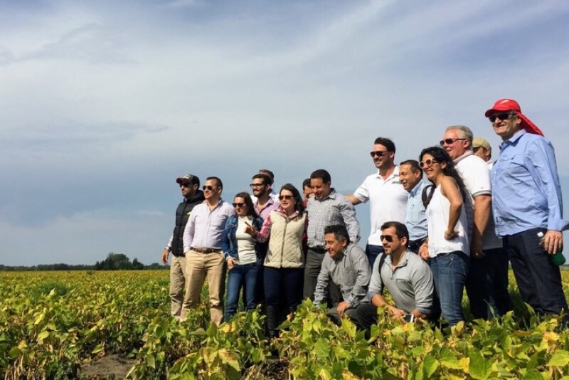 Pictured center, in sunglasses, Chris Adams hosts a delegation from Columbia. “It’s a two-way street. Foreign buyers want a face to trust,” he says.