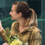 young white woman shopping holding romanesco cauliflower broccoli and asparagus