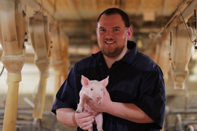 Logan Thornton with piglet