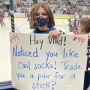 Jacey Snyder holding sign at Blue Jackets hockey game