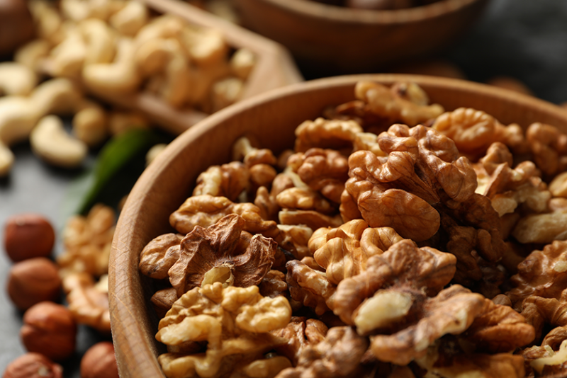 Shelled walnuts in a wooden bowl