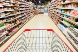 Shopping cart in grocery store aisle