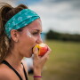 A Wanderlust 108 attendee enjoys an apple at a 2017 event in Austin, Texas, the first such event in which Rainier Fruit participated.